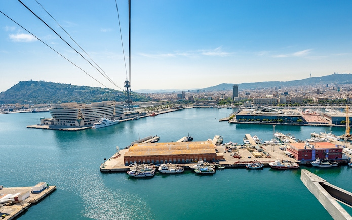 Montjuic cable car view over Barcelona harbor and cityscape.