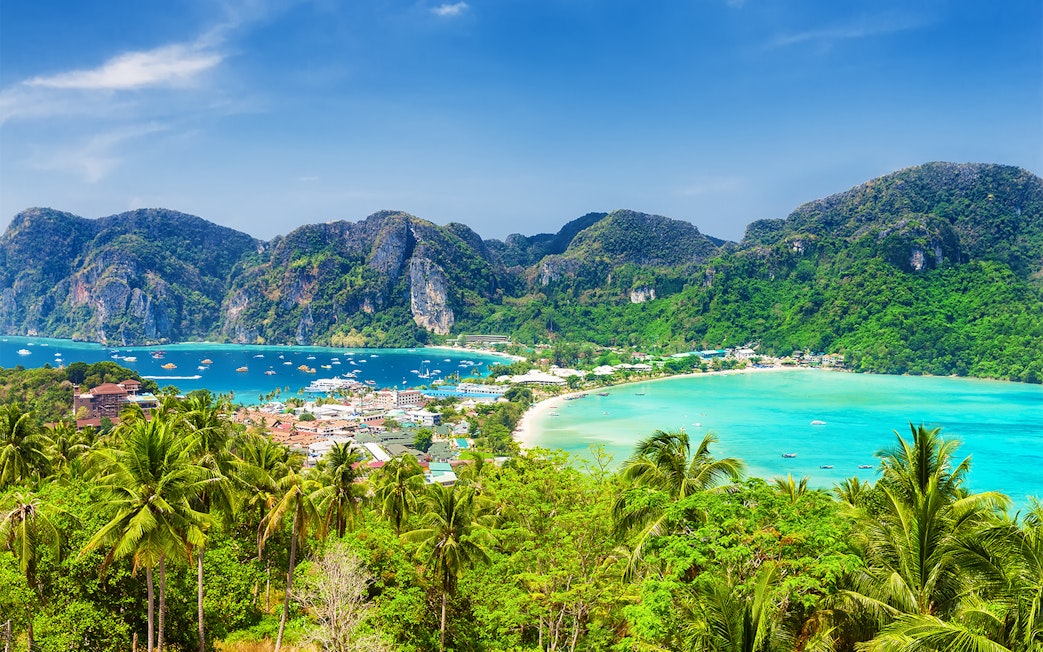 Phi Phi Island view with turquoise waters and lush hills, Phuket to Phi Phi Island tours.