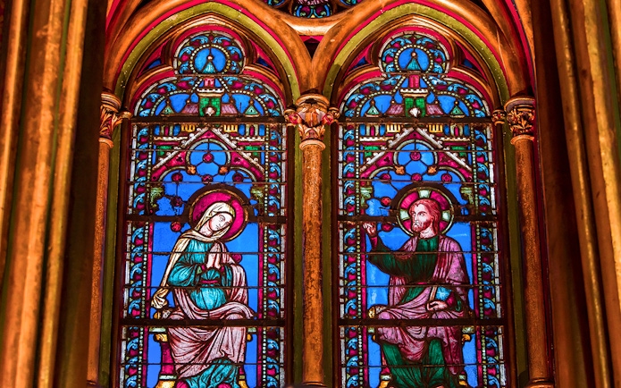 Sainte Chapelle stained glass windows depicting religious figures in Paris, France.