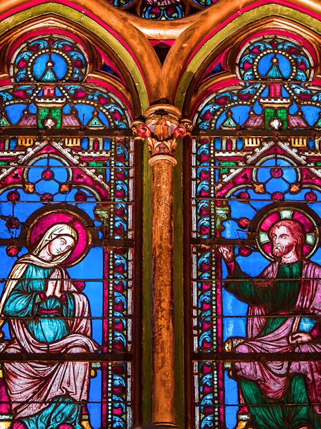 Sainte Chapelle stained glass windows depicting religious figures in Paris, France.