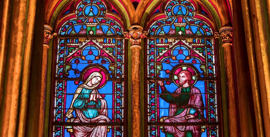 Sainte Chapelle stained glass windows depicting religious figures in Paris, France.