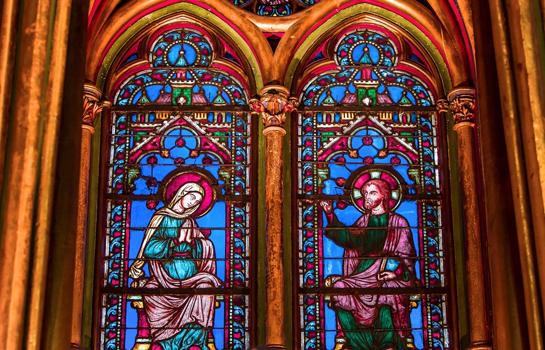 Sainte Chapelle stained glass windows in Paris showcasing intricate biblical scenes.