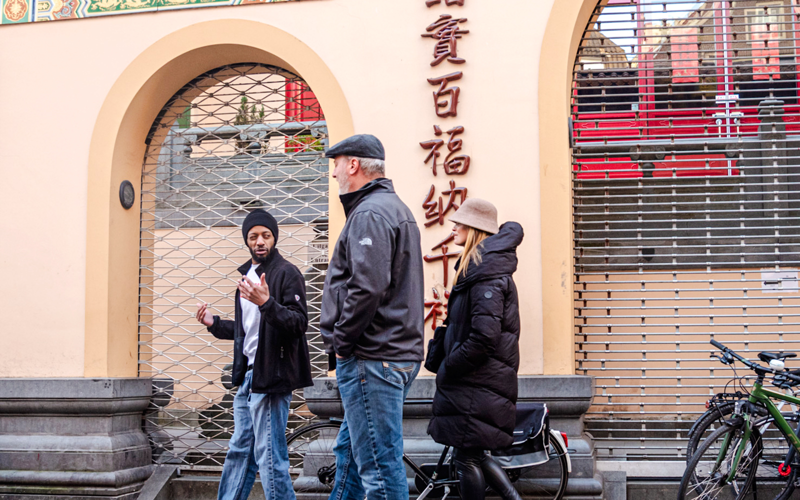 Tour guide leading a group through Amsterdam's Red Light District.