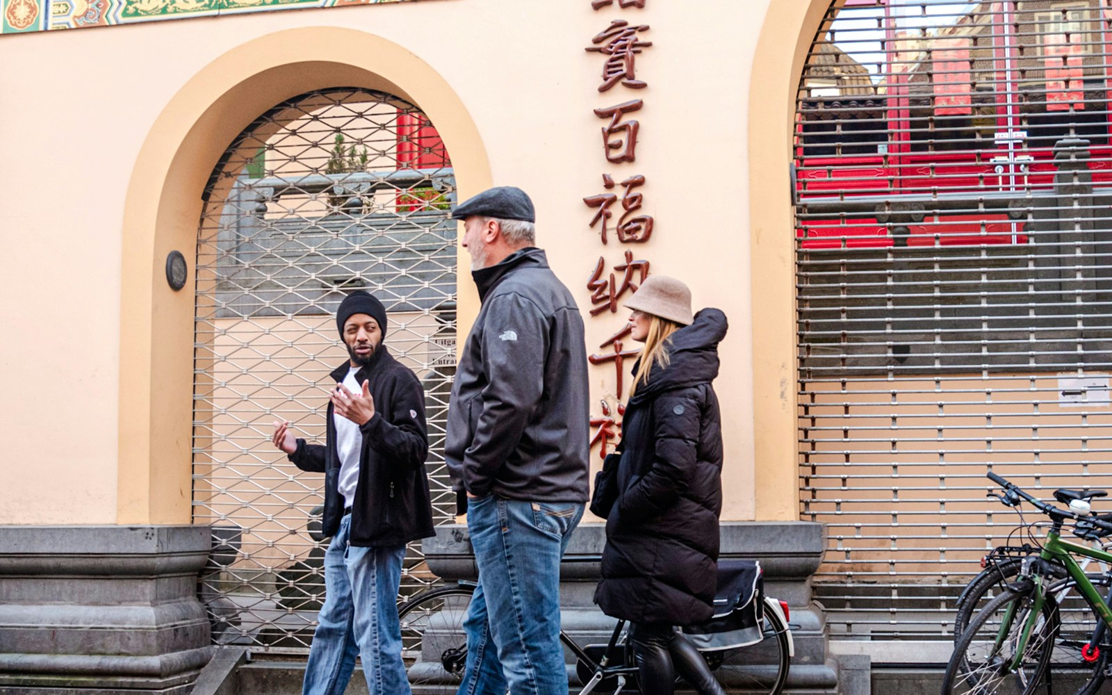 Tour guide leading a group through Amsterdam's Red Light District.