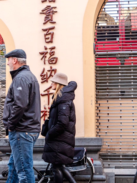 Tour guide leading a group through Amsterdam's Red Light District.