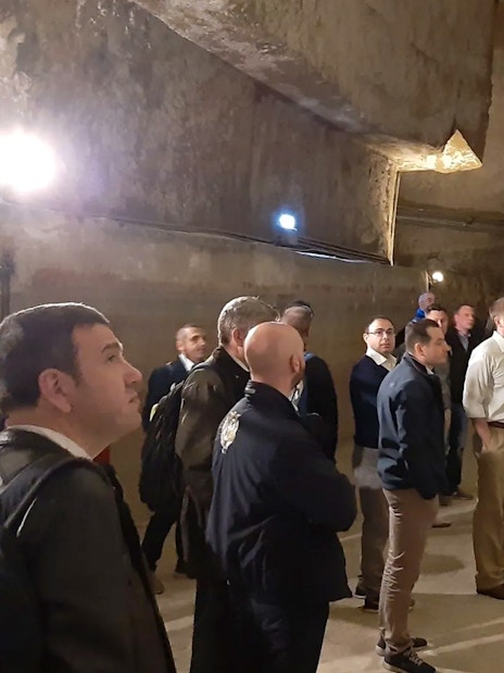 Group touring ancient tunnels in Naples Underground.