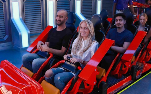 People on a roller coaster at Doha Quest, Qatar.
