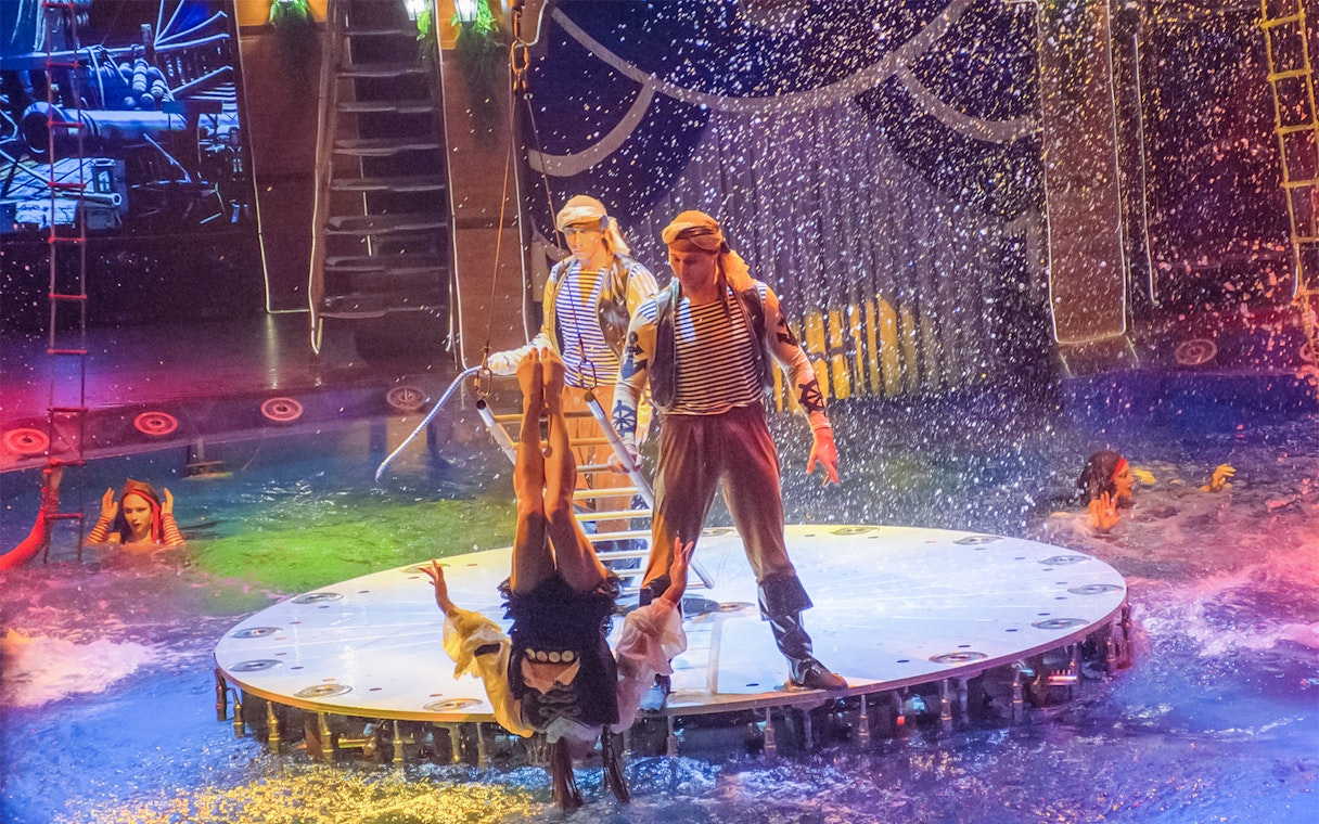 Acrobats performing at Aqua Circus Phuket with water effects.