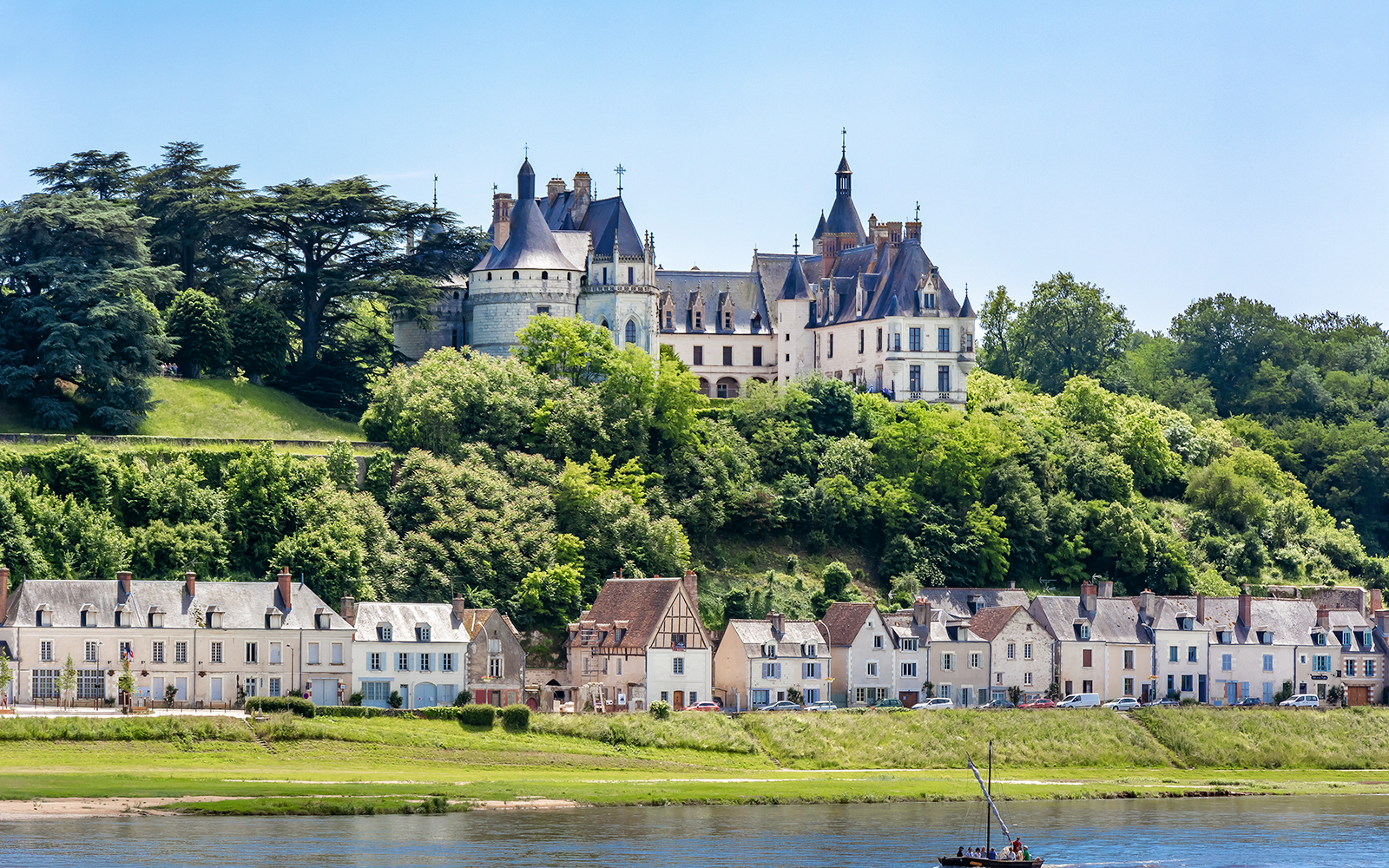 Domaine du Chaumont-sur-Loire Castle overlooking the Loire River with nearby village houses.