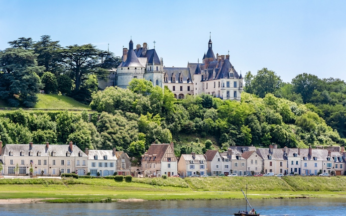 Domaine du Chaumont-sur-Loire Castle overlooking the Loire River with nearby village houses.