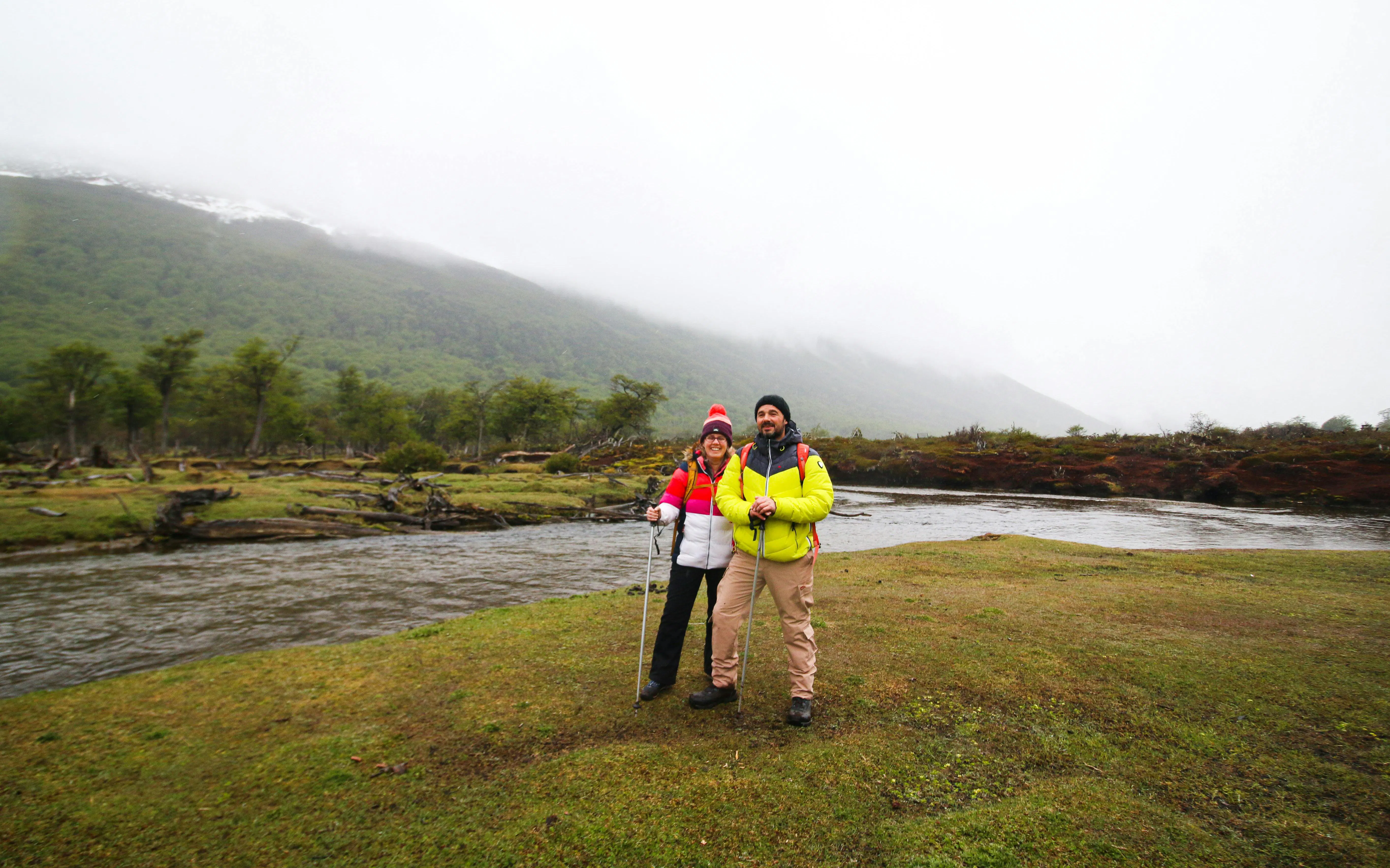 Trekking couple by river near Vinciguerra Glacier, Ushuaia.