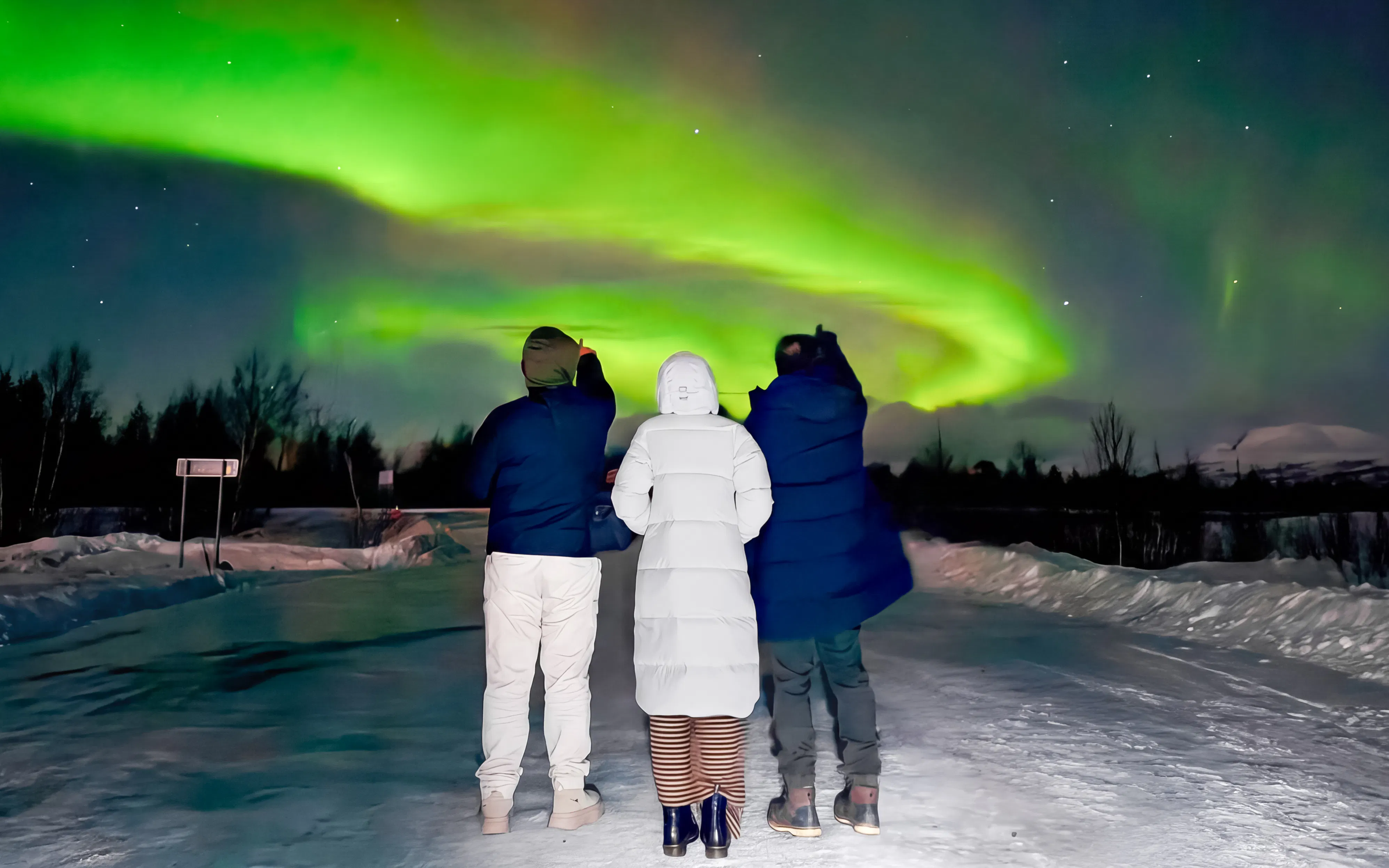 Small group watching northern lights in Kiruna, Sweden.