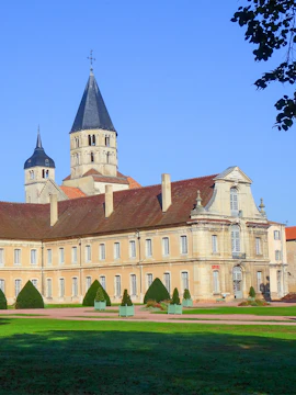 Historic building with towers at Cité internationale de la langue française, surrounded by gardens.
