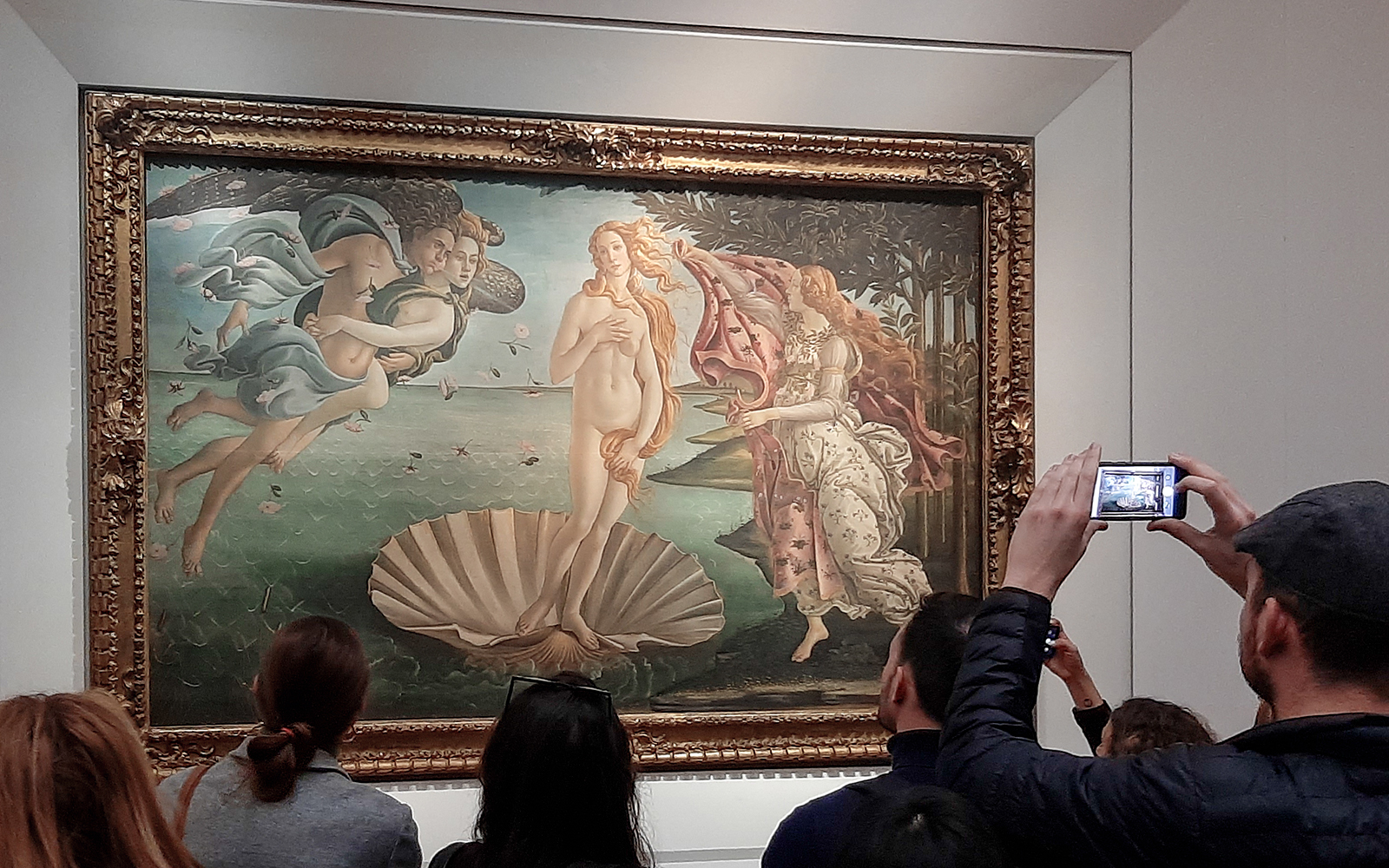 Visitors viewing Botticelli's Birth of Venus at Uffizi Gallery, Florence.