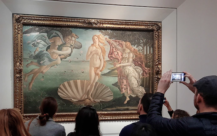 Visitors viewing Botticelli's Birth of Venus at Uffizi Gallery, Florence.