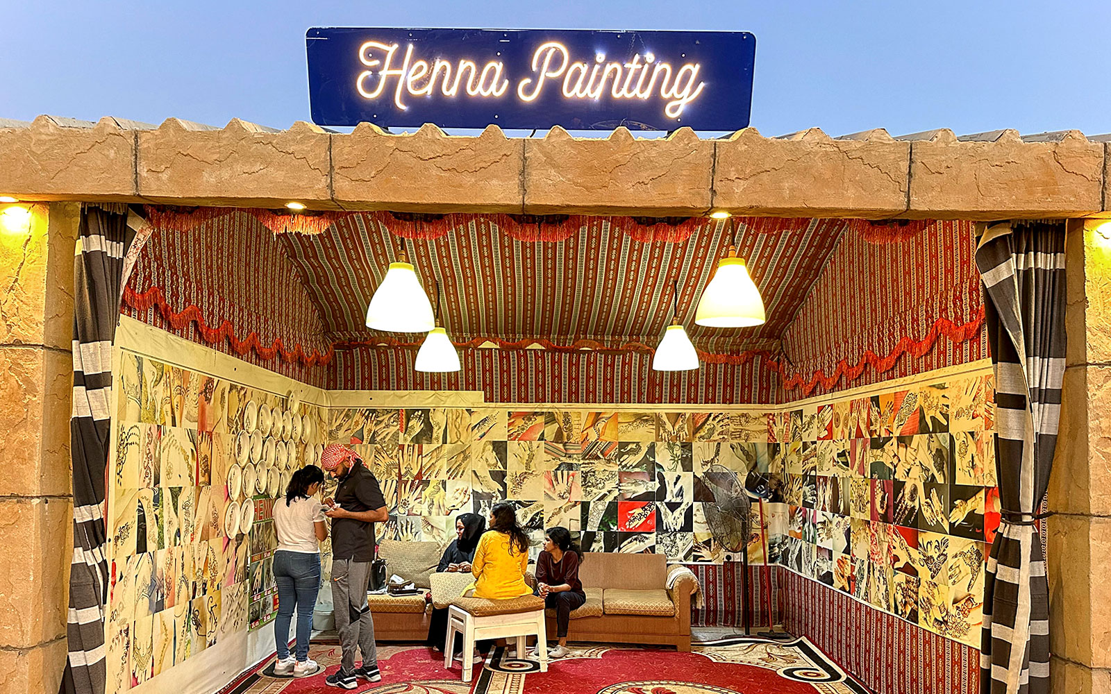 Henna painting booth during private desert safari experience.