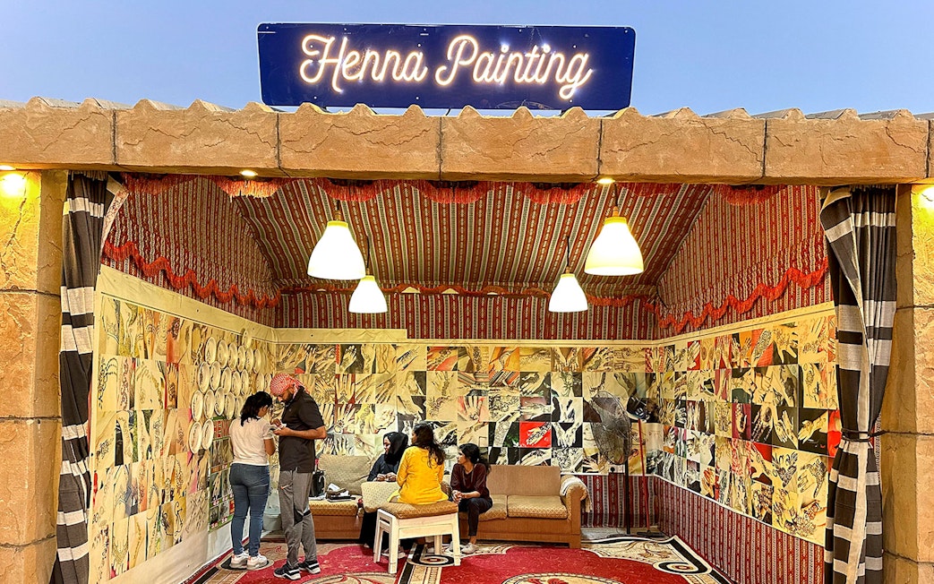 Henna painting booth during private desert safari experience.