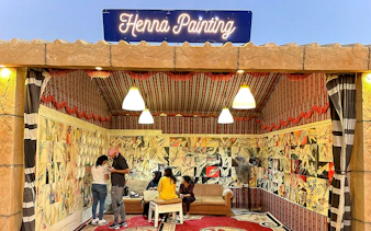 Henna painting booth during private desert safari experience.