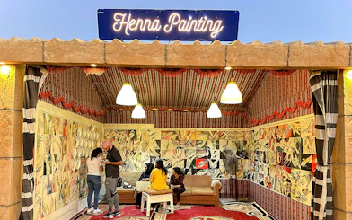 Henna painting booth during private desert safari experience.