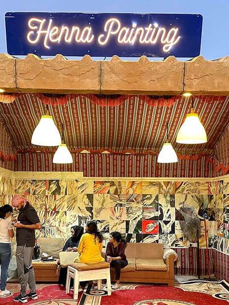 Henna painting booth during private desert safari experience.
