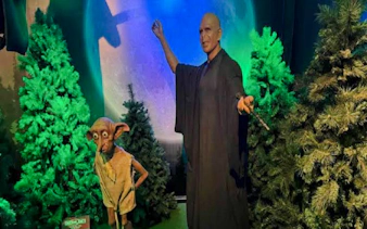 Wax figures of a wizard and elf in a forest scene at Foz do Iguaçu Wax Museum, Brazil.
