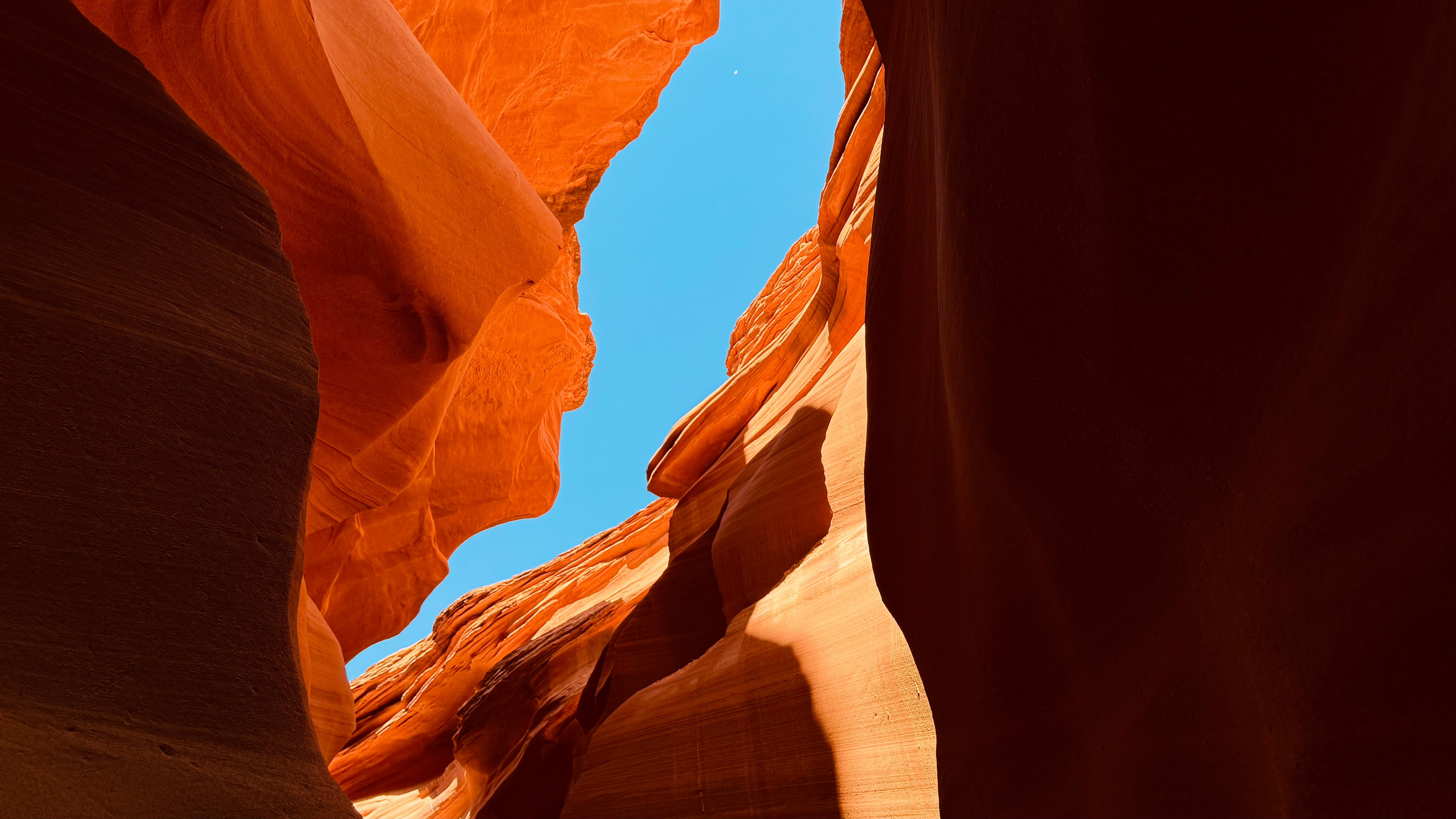 Antelope Canyon's narrow sandstone walls with a view of the sky above.