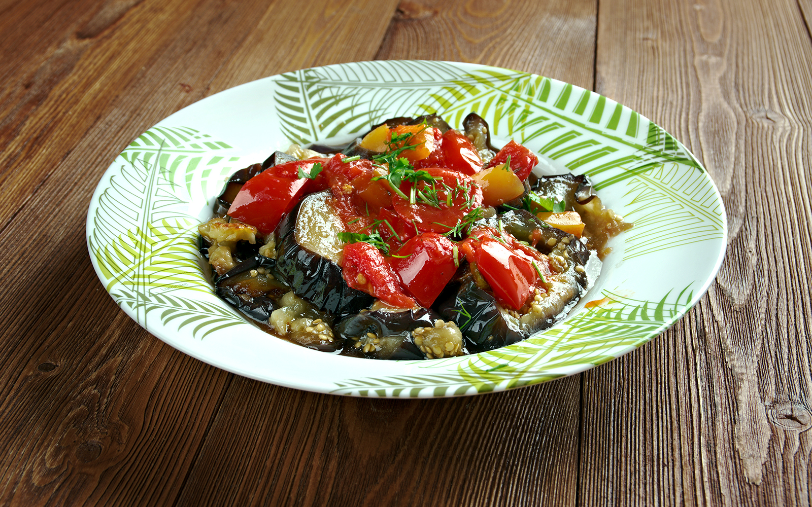 Mallorca Tumbet dish with vegetables and sauce on a white plate.