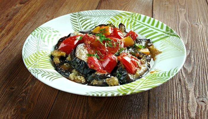 Mallorca Tumbet dish with vegetables and sauce on a white plate.