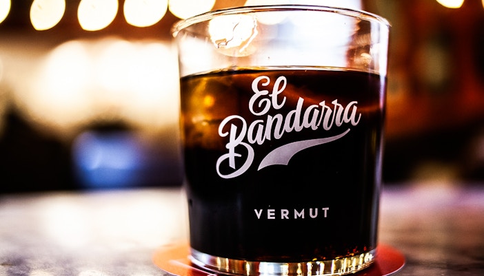 Glass of El Bandarra vermut on a table during La Barceloneta food tour.
