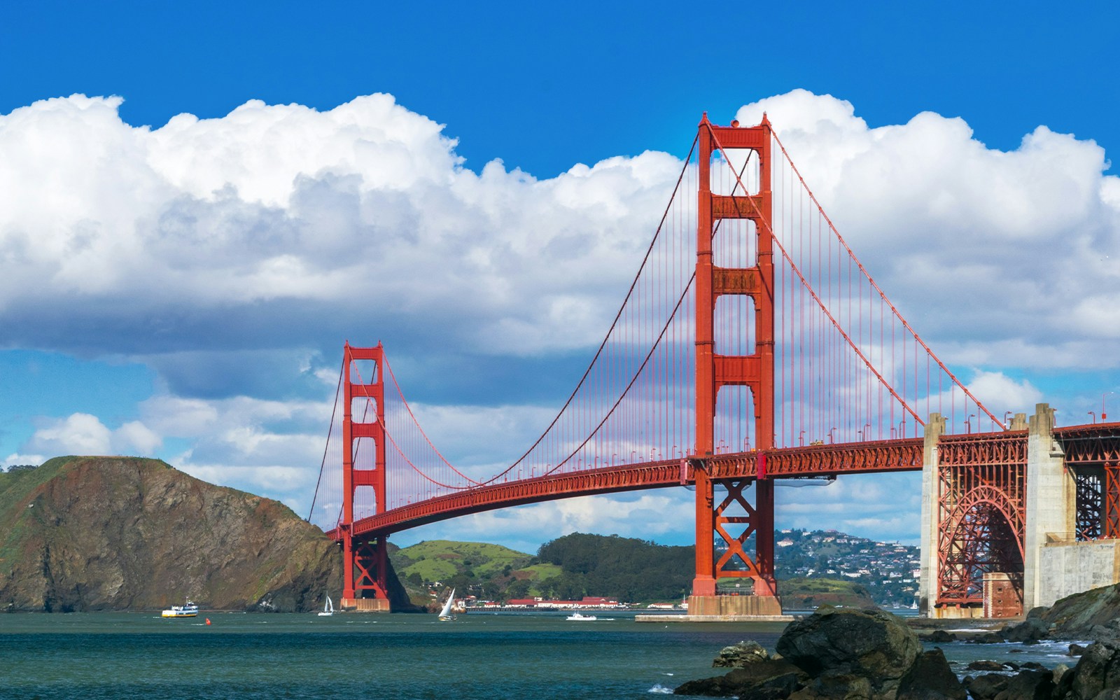 Golden Gate Bridge spanning San Francisco Bay with city skyline in the background.