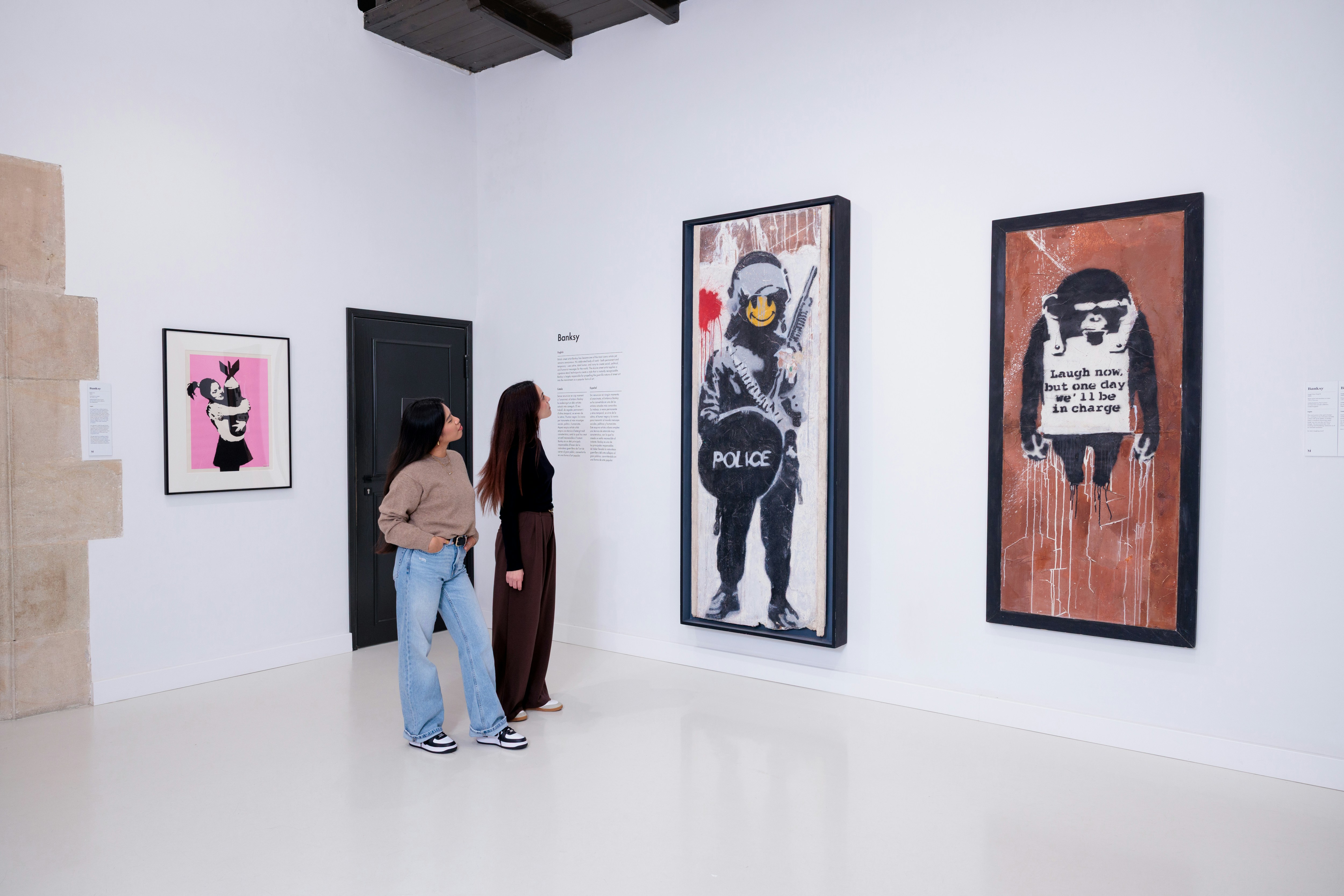 Visitors viewing Banksy artwork at Moco Museum Barcelona.