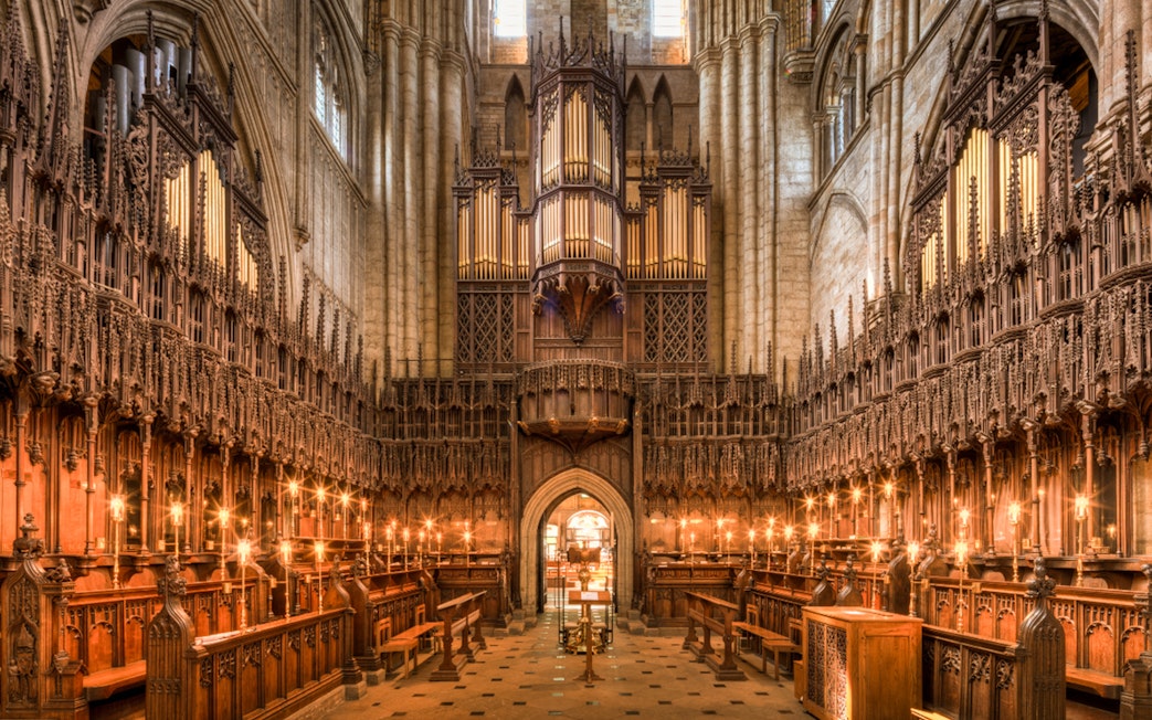 Interior of the Cathedral of Barcelona showcasing ornate wooden choir stalls and grand organ.