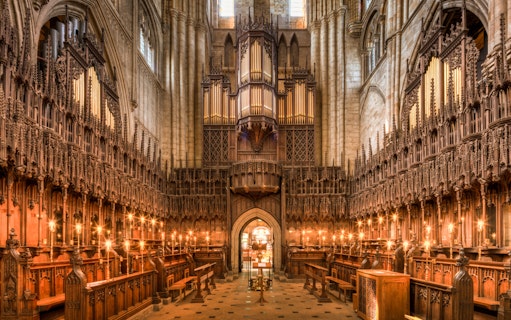 Interior of the Cathedral of Barcelona showcasing ornate wooden choir stalls and grand organ.