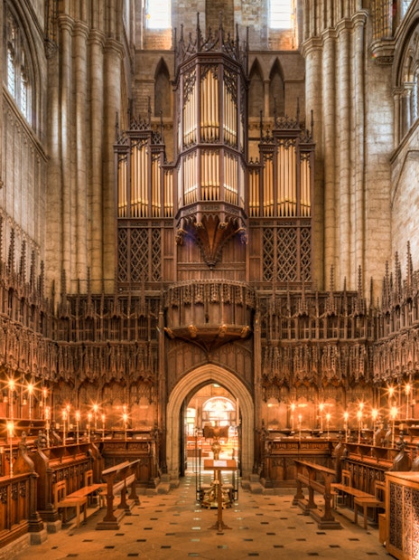 Interior of the Cathedral of Barcelona showcasing ornate wooden choir stalls and grand organ.
