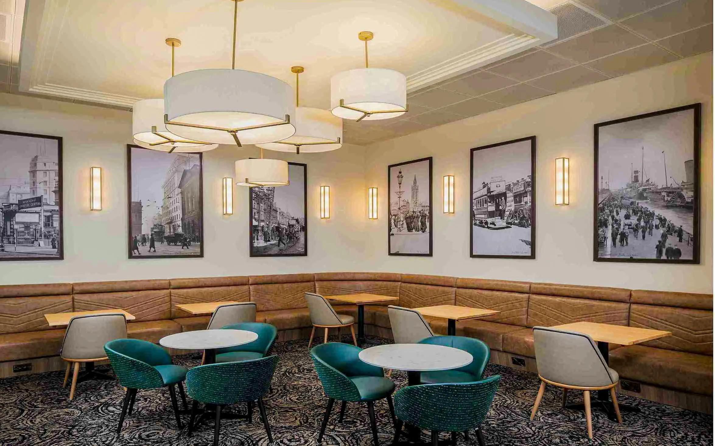 Aspire Lounge seating area with vintage city photos, John Lennon Airport.