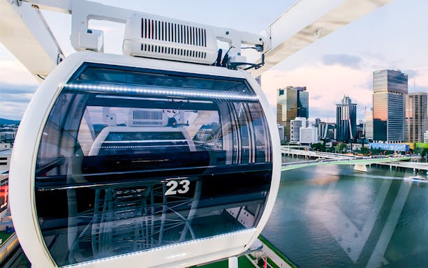 Ferris wheel cabin overlooking Brisbane skyline and river.