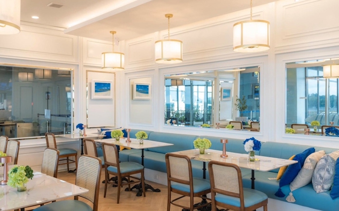 Coral Lounge seating area with tables and chairs at Phuket International Airport.