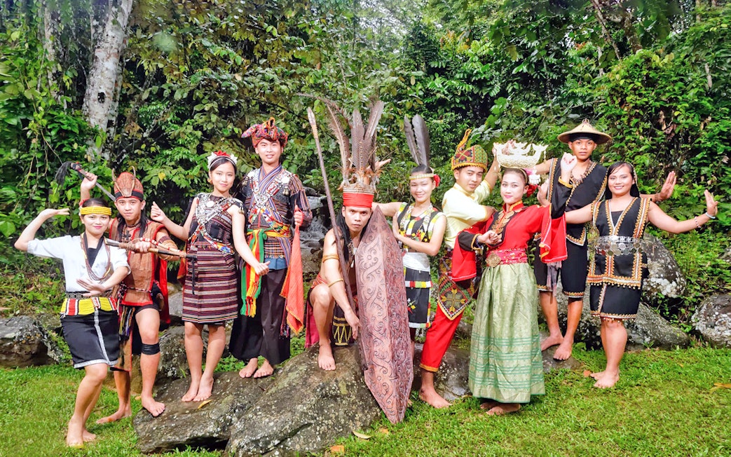 Traditional dancers in cultural attire at Mari Mari Cultural Village tour.