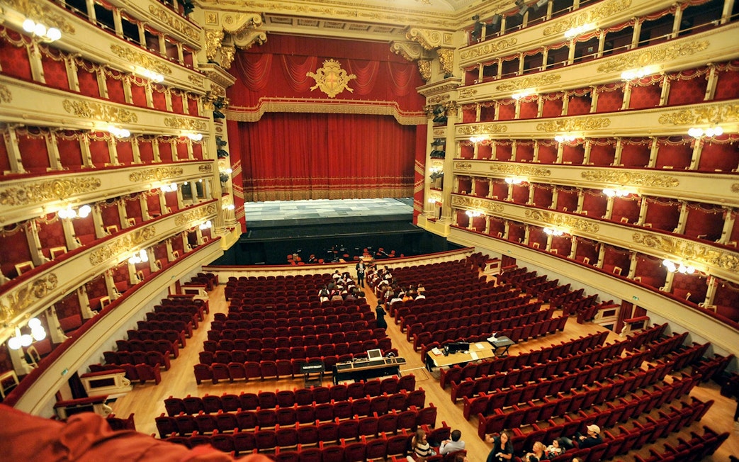 La Scala theater interior with red seats and ornate balconies, Milan.