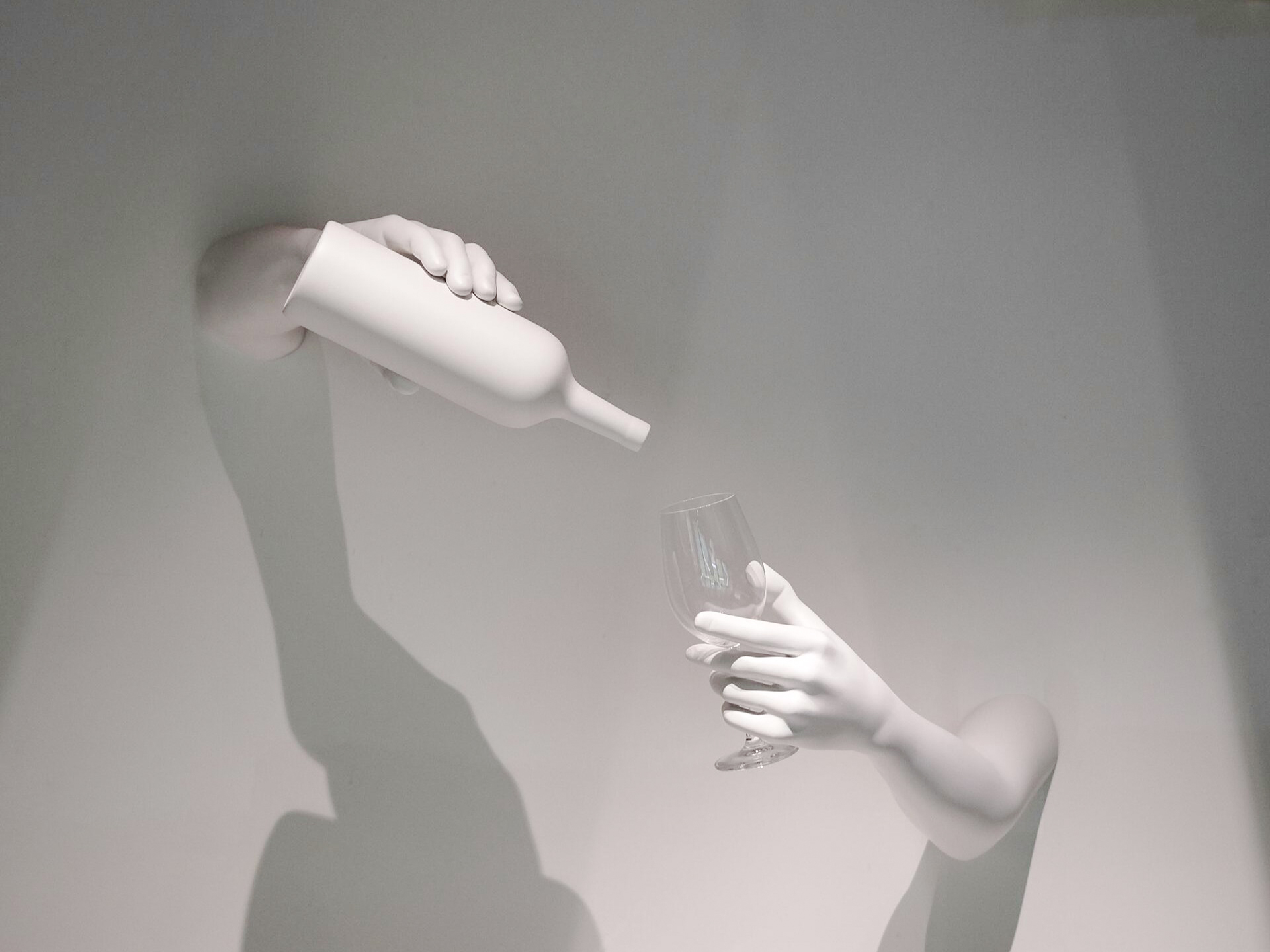 Hands pouring wine into a glass, representing The Wine Experience.