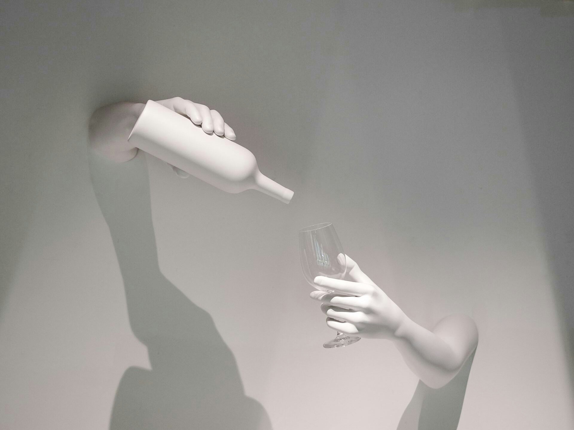 Hands pouring wine into a glass, representing The Wine Experience.