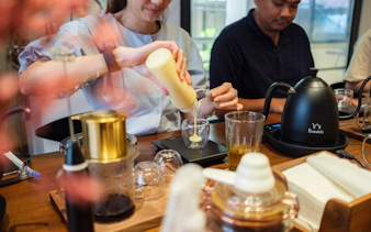 Participants making Vietnamese coffee at a workshop in Hồ Chí Minh City.