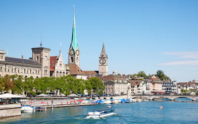 Boat on Lake Zurich with city skyline and historic buildings, Zurich, Switzerland.