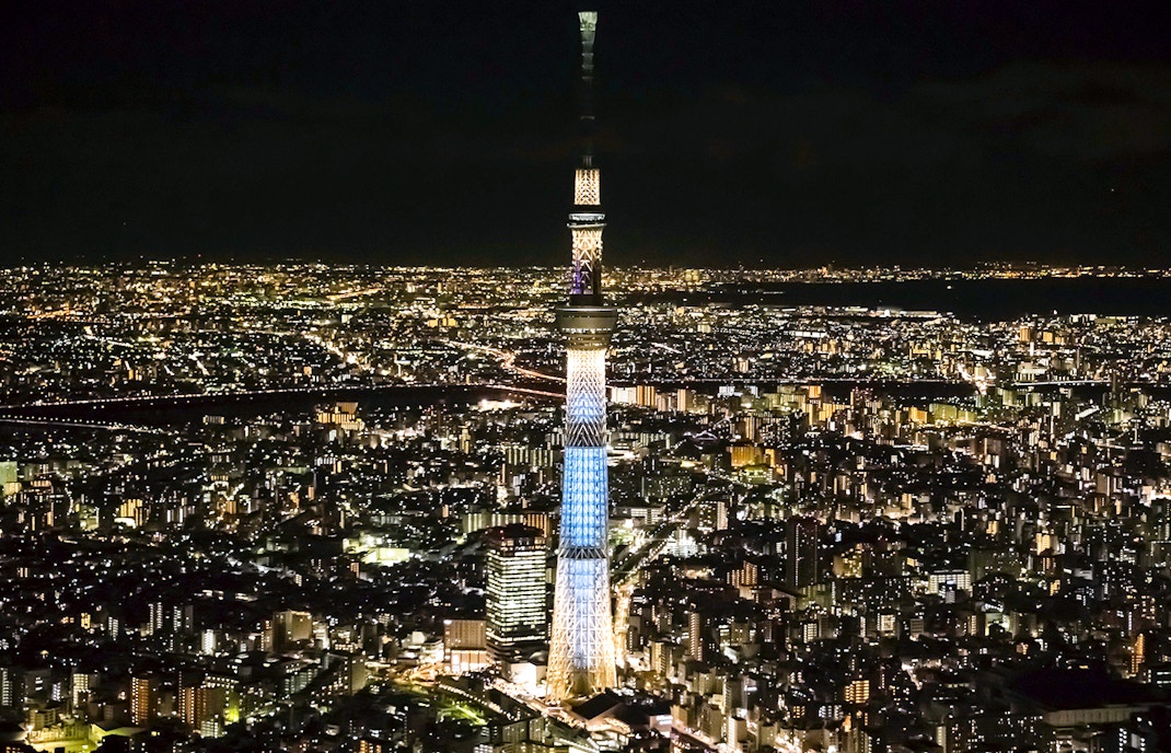 Tokyo Skytree illuminated at night with cityscape view, highlighting the tower's observation deck experience.