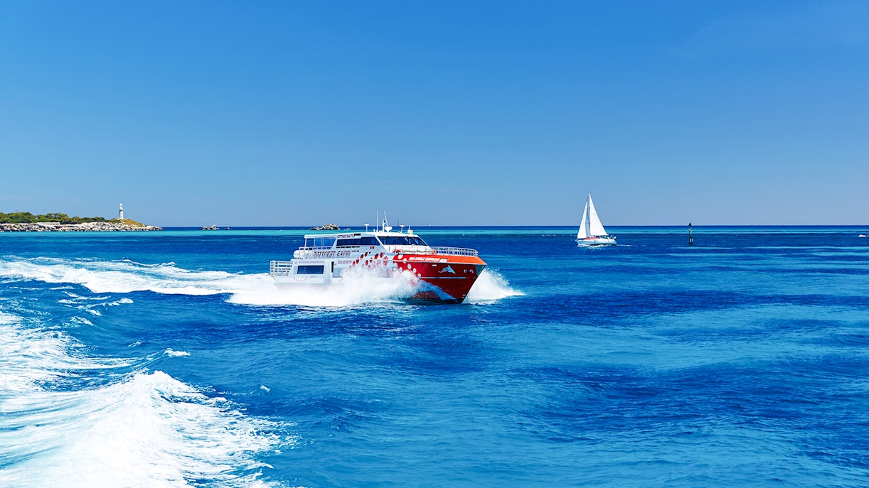 Ferry and sailboat on turquoise waters near Rottnest Island, Western Australia.