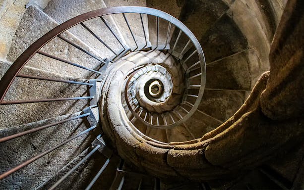 Spiral stone staircase in historic building, Combo tour.
