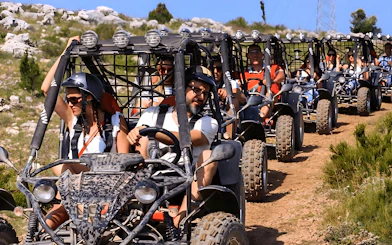 Group driving buggies on a dirt trail during Alanya Buggy Safari tour.