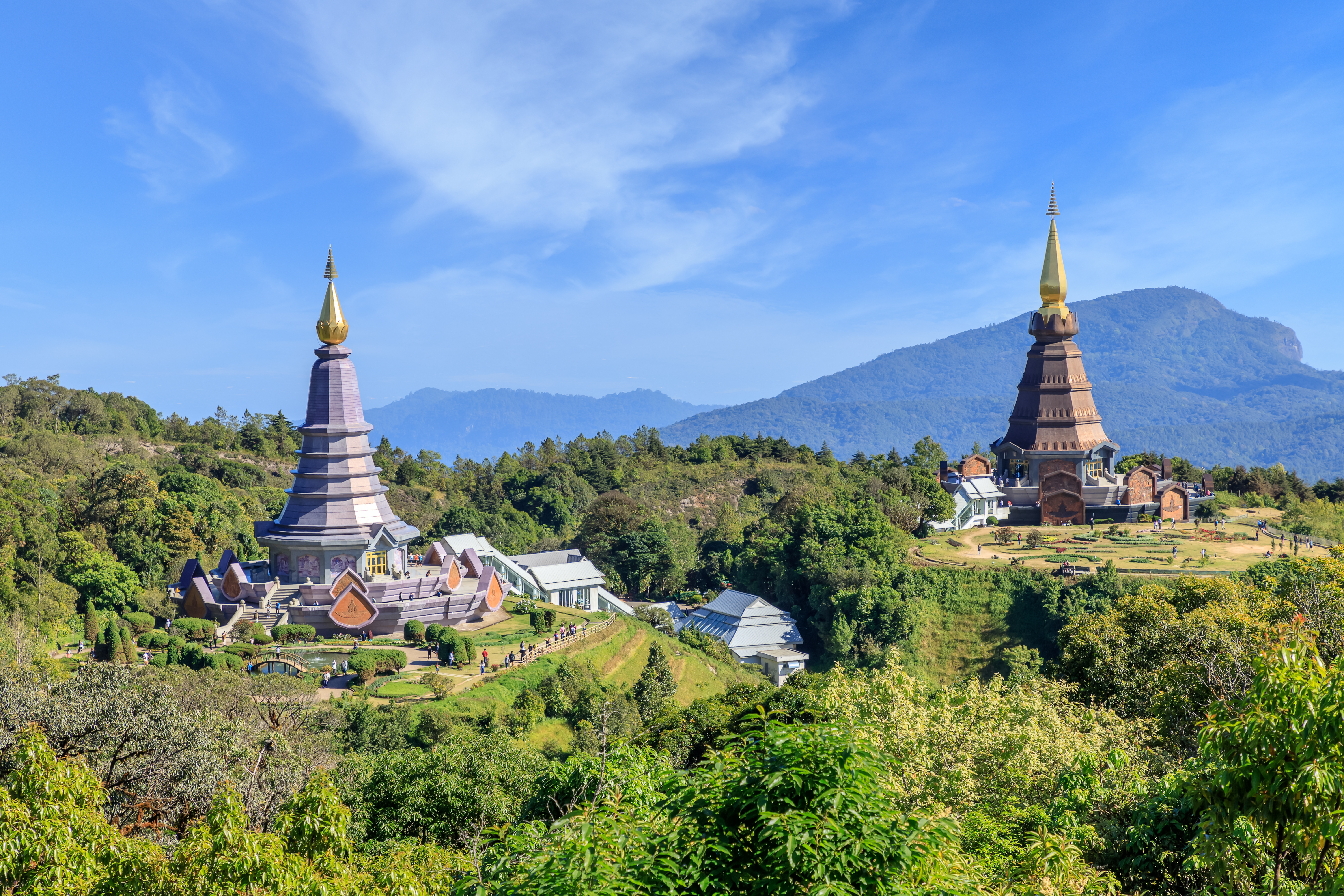 Noppamethanedon and Nopphonphusiri pagodas on Kew Mae Pan trail, Doi Inthanon, surrounded by lush greenery.