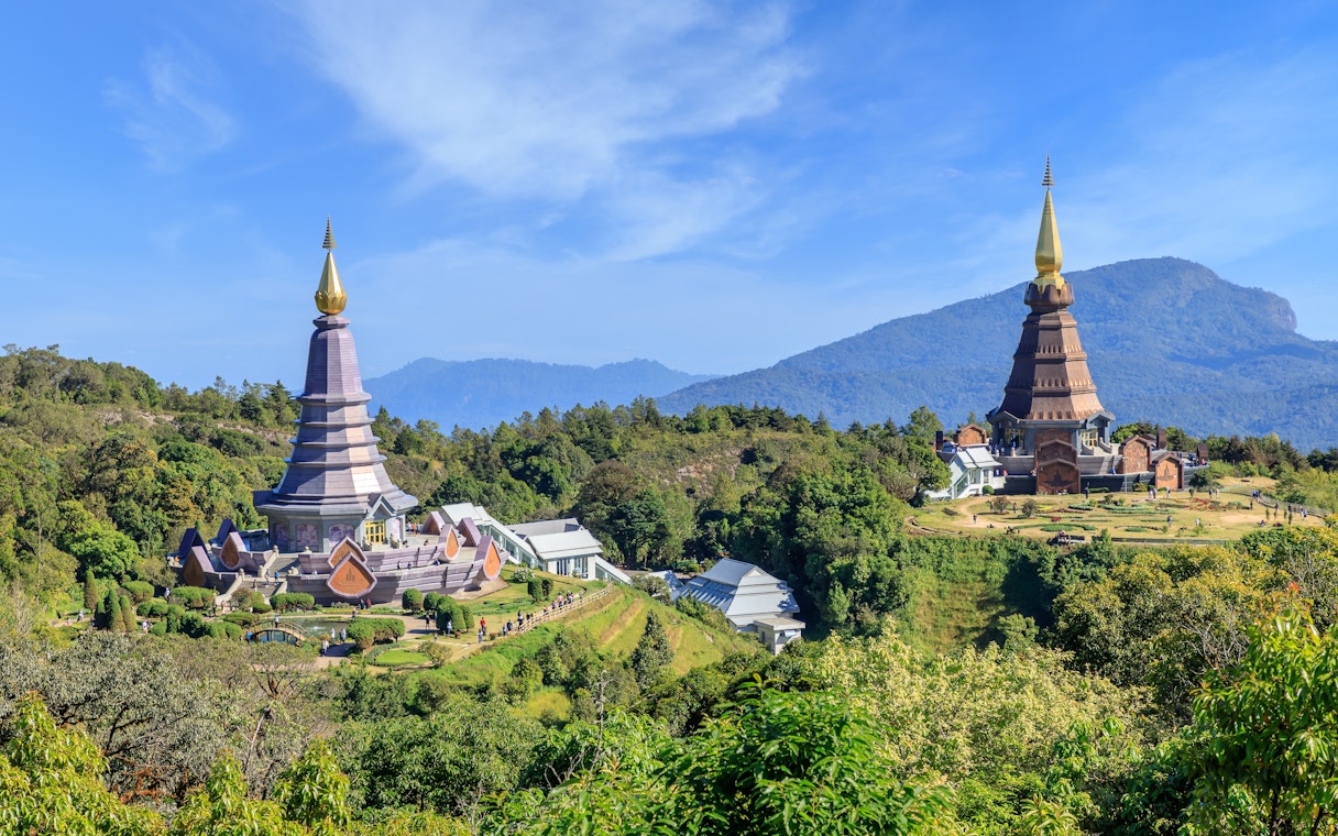 Noppamethanedon and Nopphonphusiri pagodas on Kew Mae Pan trail, Doi Inthanon, surrounded by lush greenery.