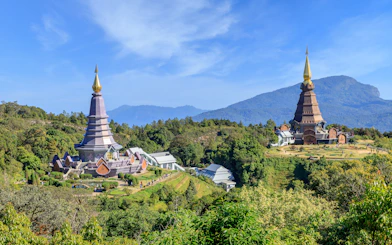 Noppamethanedon and Nopphonphusiri pagodas on Kew Mae Pan trail, Doi Inthanon, surrounded by lush greenery.